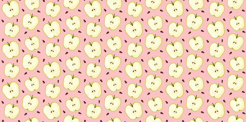Cut green apple with seeds pattern on pink background. Fruit ornament