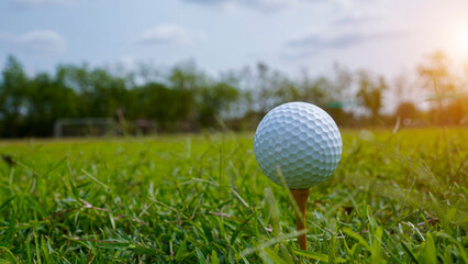 golf ball on tee in beautiful golf course with sunset.