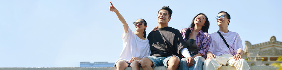 Web banner with smiling Vietnamese young people looking at sky