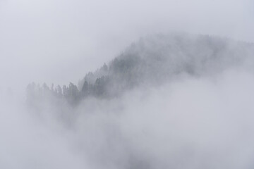 Obraz na płótnie Canvas A mountain in the fog