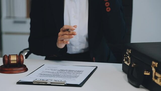 Lawyer, legal advisor, businessman brainstorming information on agreement details Business contracts in legal processing books for accuracy in contract documents. joint financial investment.