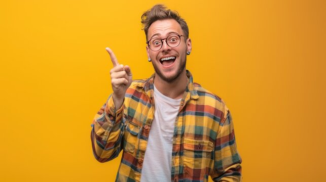 Smiling young caucasian hispanic man make hand pointing with finger gesture on yellow background.