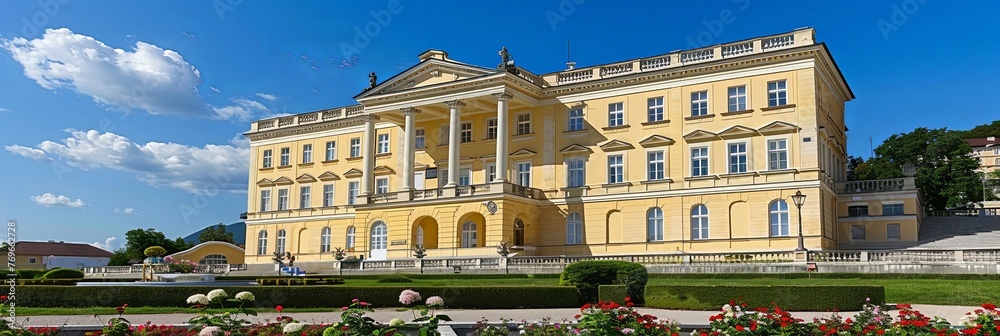 Poster a grand yellow building stands proudly as a backdrop to a colorful array of vibrant flowers in full 
