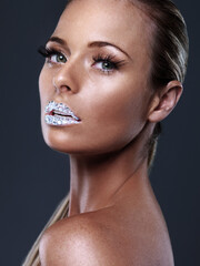 Beauty, portrait and woman with crystal on lips in studio with jewelry isolated on black...