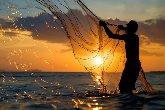 Silhouette of a fisherman casting a fishing net into the sea