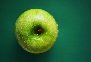 Ripe green apple on green background