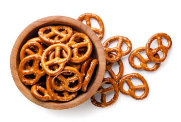 Pretzels in a plate and scattered close-up on a white. Top view