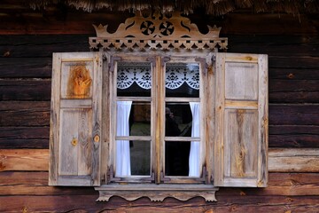 Close up of windows with wooden shutters in traditional cottage in Kurpie, culture region of Poland, Kadzidlo