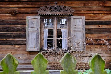 Close up of windows with wooden shutters in traditional cottage in Kurpie, culture region of Poland, Kadzidlo