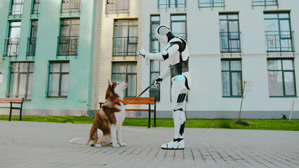 Young cute dog jumping on hind legs and asking for tasty snack from humanoid robot hands. Outdoor...