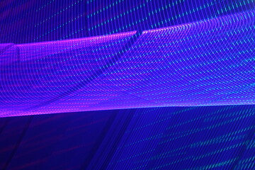 Large display featuring a pattern of blue and pink lights radiating outward along distinct lines