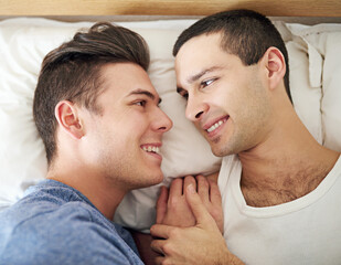 Men, gay and couple or bed rest in apartment happy with lgbt pride with comfortable love, happiness or connection. Male person, queer and smile with bonding support in home together, calm or peace