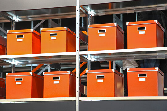 Orange Boxes With Documents at Big Metal Shelf in Storage Room