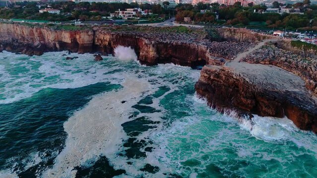 Aerial drone footage of the road along the rocky coast of the Atlantic ocean. Boca do inferno, Portugal
