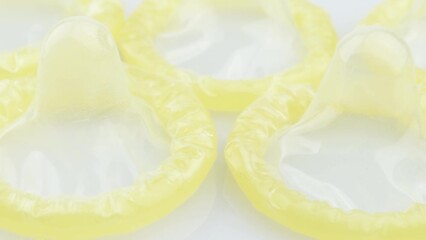 Closeup video of standard condoms on a white background