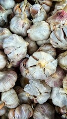 Top view of a stack of fresh garlic