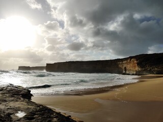 Fototapeta na wymiar Scenic beach with waves and cliffs backdrop. Twelve Apostles, Melbourne