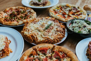 Vivid view of a variety of delicious pizzas arranged on a table