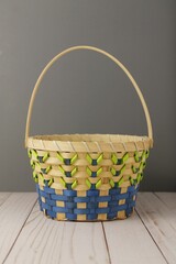 Yellow basket on wooden surface