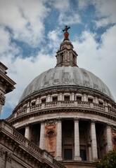 Fototapeta na wymiar Low angle of St Paul's Cathedral under a cloudy sky in London, England, UK