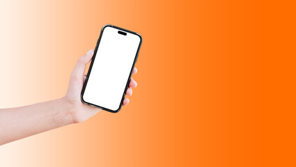 Close-up of hand holding smartphone with blank on screen isolated on background of orange.