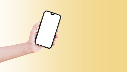Close-up of hand holding smartphone with blank on screen isolated on background of pastel yellow.