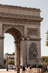 two people walking towards the arc de triovieres in paris