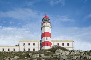 Silleiro Lighthouse against a backdrop of a dramatic cloudy blue sky