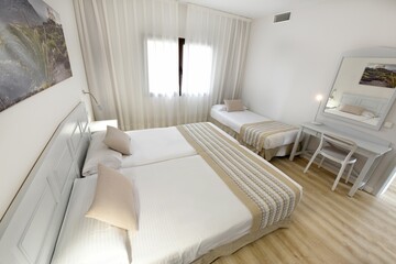 Fototapeta na wymiar Modern and clean bedroom with single beds and other elegant details