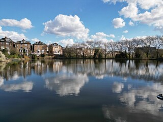 Fototapeta premium Aerial view of Hamstead Heath Park surrounded by buildings and water in London