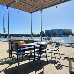 a wooden table that is next to some chairs and a water