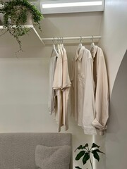 Selection of freshly washed clothes hanging on a clothesline near the window