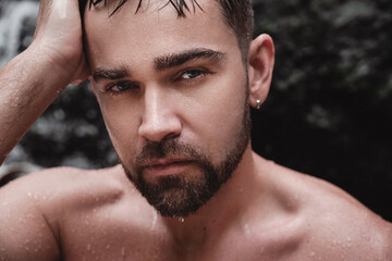 Closeup portrait of handsome bearded man with wet skin and hair