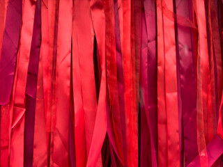 texture red ribbons hanging vertically - obrazy, fototapety, plakaty