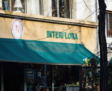 Strasbourg, France - Mar 20, 2024: A store Interflora Florist front with a green awning providing shade and protection from the elements.