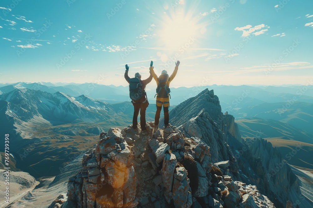 Wall mural Visualize three people at the pinnacle of a mountain, joining hands and raising them high in a jubilant gesture of overcoming obstacles and achieving success together