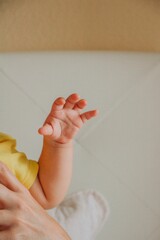 Loving mother holding her newborn child close to her chest in a warm embrace