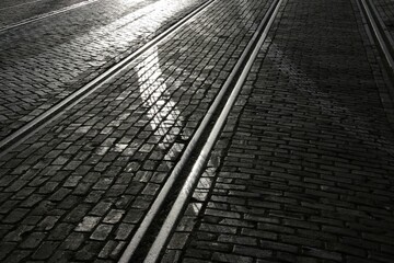 Is an image of vintage railway tracks situated on a city street - obrazy, fototapety, plakaty