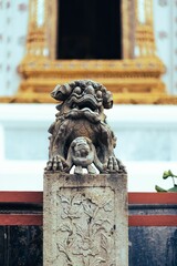 Sculpture of an ornate dragon in front of a golden temple entrance