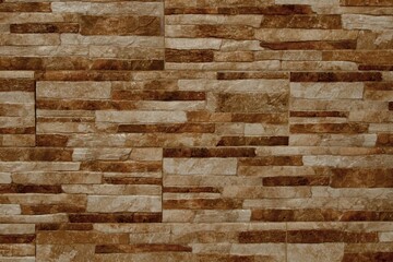 Aged brick wall featuring a tan and brown stone paneled finish