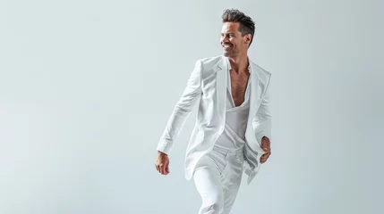 Foto op Canvas glamorous smiling beautiful man 40 years old in fashion modern white clothes posing for fashion shoot, white background, in move, low angle, full body,  © chaynam