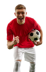 Winning spirit of soccer player as he holds ball, his gaze fixed on camera, fist clenched in...