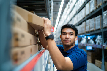 A man in a blue shirt is reaching for a box on a shelf. Concept of determination and focus as the...