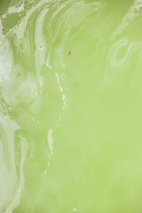 Closeup of green transparent clear calm water surface texture with splashes and bubbles.