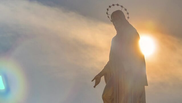 Holy Mary monument with sun behind it on square in front of the Cathedral timelapse in Zagreb, Croatia. Close up view. Blue sky at sunny day.