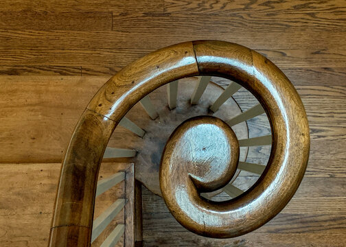 A curled oak bannister and newel post