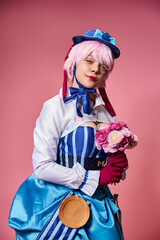 appealing cute female cosplayer in vibrant costume holding pink flowers and looking at camera