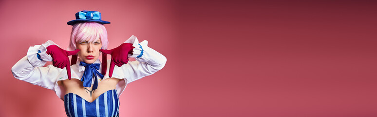 young sexy woman with red gloves and blue hat showing crying gesture on pink backdrop, banner
