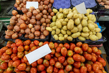 Stack of ripe tomatoes, onions and potatoes at the brazilian market stall. Sao Paulo city, Brazil.