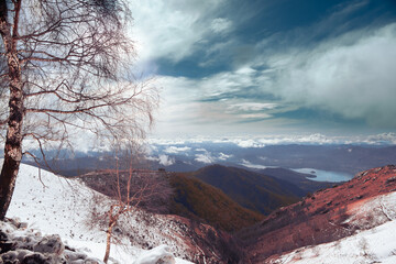 Suggestive view from Mottarone mountain on a winter morning, with lake Orta and snowed mountains. Piedmont - Italy.